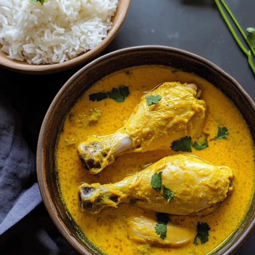 Kuku Paka, often referred to as East Africa's answer to coconut chicken curry, has its roots deeply embedded in the coastal regions of Kenya and Tanzania. The dish is a true reflection of the region's rich history of trade and cultural exchange, bringing together influences from Arab, Indian, and local cuisines. This fusion is evident in the use of coconut milk, spices, and cooking techniques that have been passed down through generations.